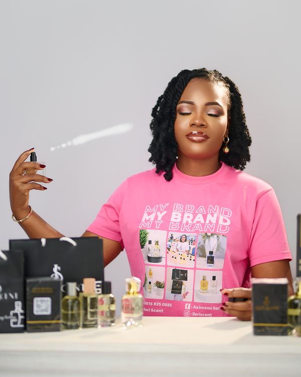 Founder of Ileri Scent testing a fragrance beside the collection